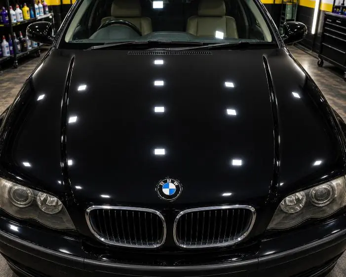 After: A BMW bonnet with dull, oxidised paint, and the same bonnet after the dead layer was polished away.