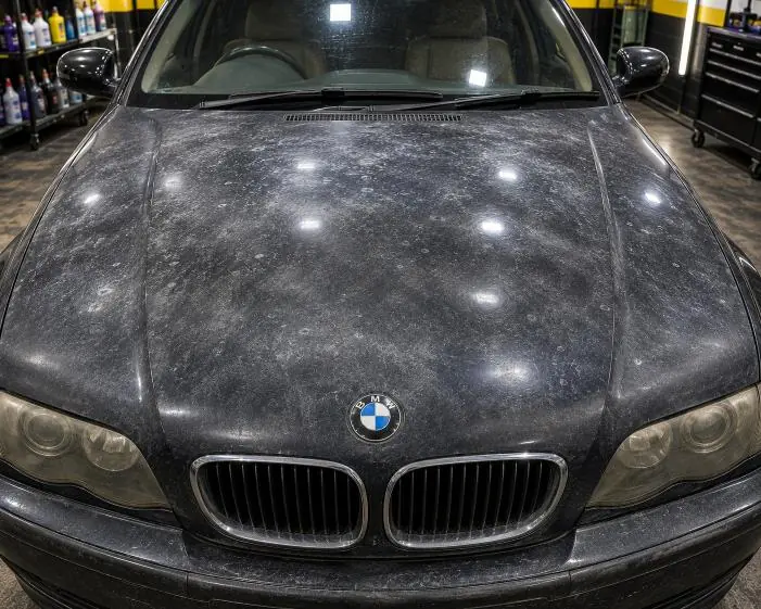Before: A BMW bonnet with dull, oxidised paint, and the same bonnet after the dead layer was polished away.