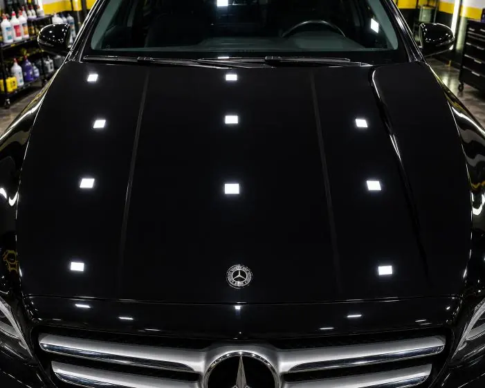 After: Wash marks on dark paint, removed by machine polishing in our studio.