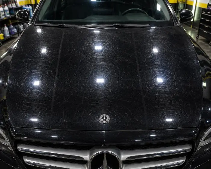 Before: Wash marks on dark paint, removed by machine polishing in our studio.